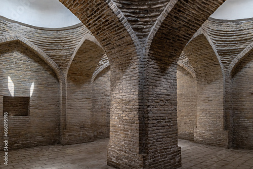 Interior of ancient building with arched brick walls and round whitewashed ceiling, Khiva, Uzbekistan