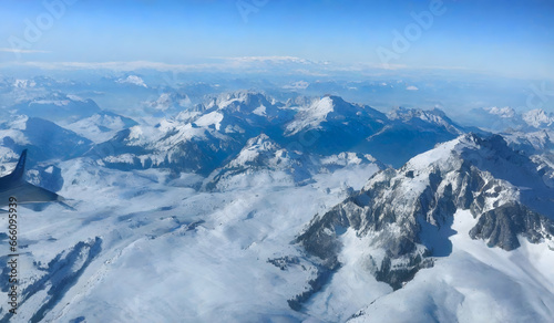 Aerial view of Alps mountain range with snow and blue sky. © anamulhaqueanik