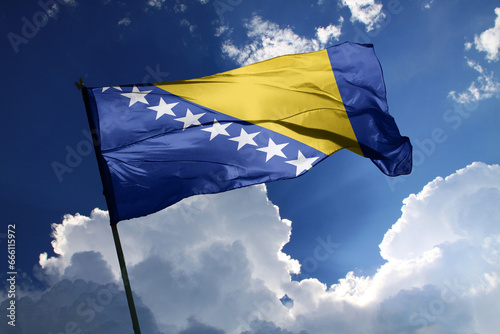 national flag of Bosnia and Herzegovina waving in the wind on a clear day. photo