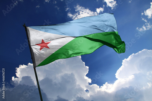 national flag of Djibouti waving in the wind on a clear day.
