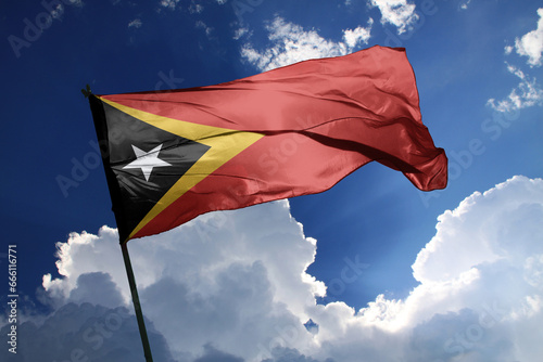 national flag of Timor leste waving in the wind on a clear day.