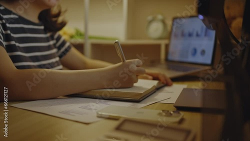 Young woman taking teaching notes and doing homework in the middle of the night, Take notes messages during the teacher's teaching, Doing homework in the middle of the night