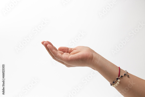 Right hand of woman who wear bracelet showing on white background. A right hand that makes a gesture of asking for or protecting something. photo