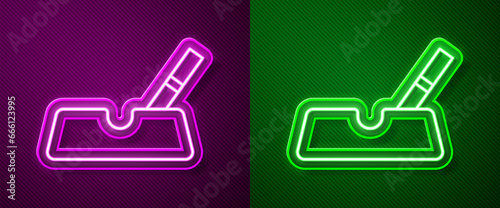 Glowing neon line Ashtray with cigarette icon isolated on purple and green background. Vector