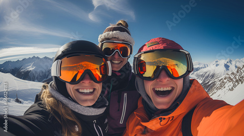 Amid the mountain backdrop, friends on skis capture the moment with a joyful summit selfie