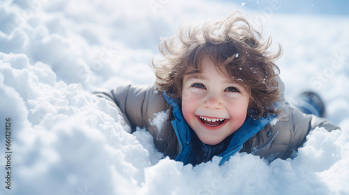 Portrait of a cute little boy having fun in the snow. Selective focus photo