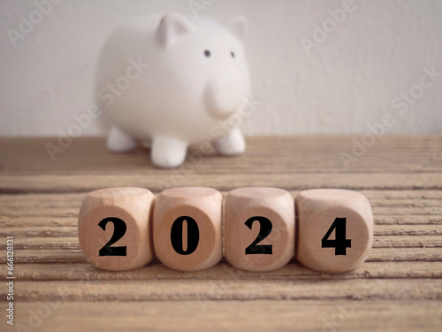 New Year financial plan concept. 2024 written on wooden blocks. With blurred styled background.