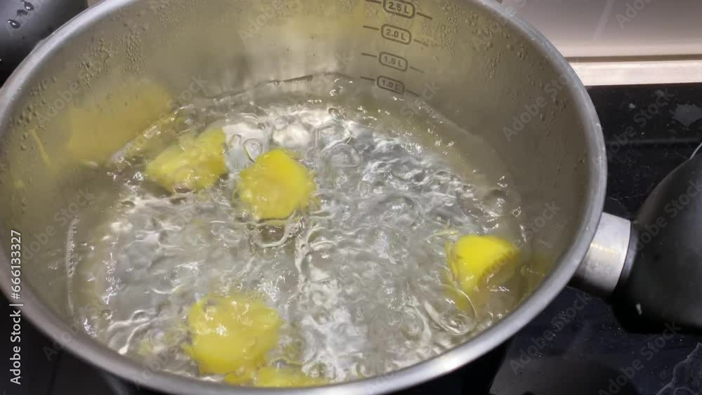 Potatoes are boiling in a saucepan on a electric stove. video as water bubbles and the potatoes cook. Potatoes are boiling in a saucepan on a electric stove. video as water bubbles and the potatoes cook.