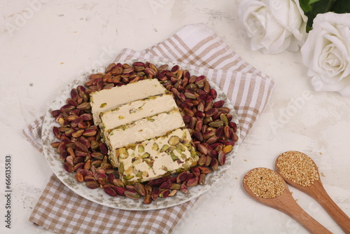 Pistachio Halva Slices  on a plate  with Wooden Spoon and Pistachio photo