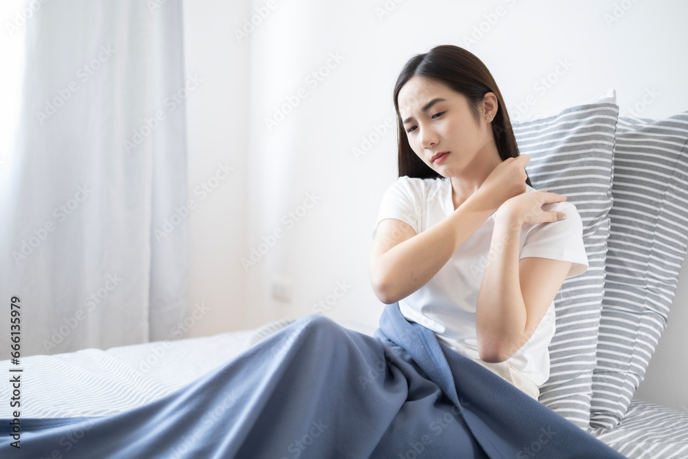 Young Asian lazy woman got shoulder ache after waking up in morning, woman feel pain at shoulder after woken up. Young Asian lazy woman got shoulder ache after waking up in morning, woman feel pain at shoulder after woken up.