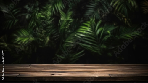 Long wooden table against a background of dark green tropical leaves. Template for advertising  design of your product  presentation of cosmetics  mockup. Tropical jungle background