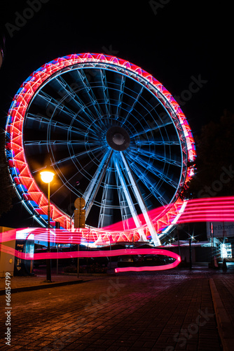 Ferris wheel with light trails. Kolobrzeg at night. Kołobrzeg is city in Poland. 