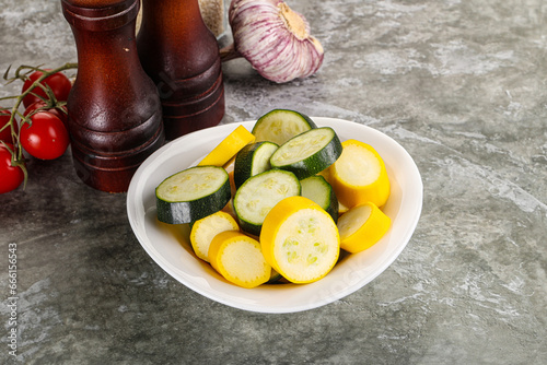 Sliced raw young green and yellow zucchini