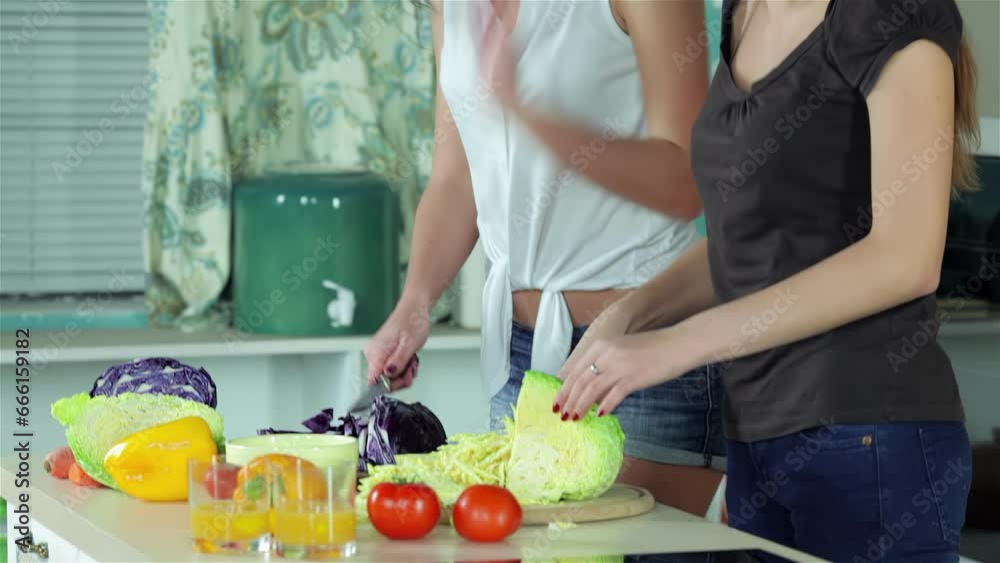 Two smiling girlfriends sliced vegetables Two smiling girlfriends sliced vegetables