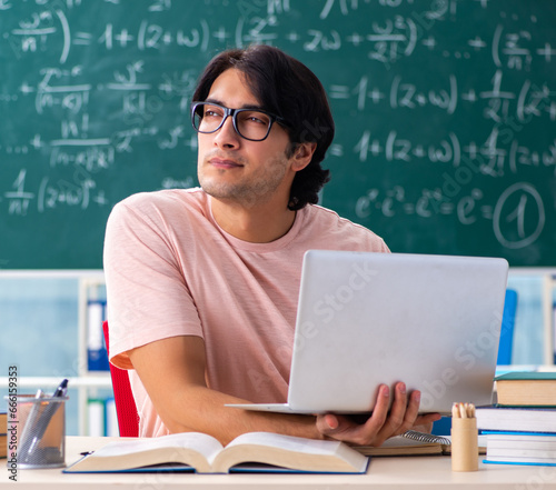 Young male student in the classroom