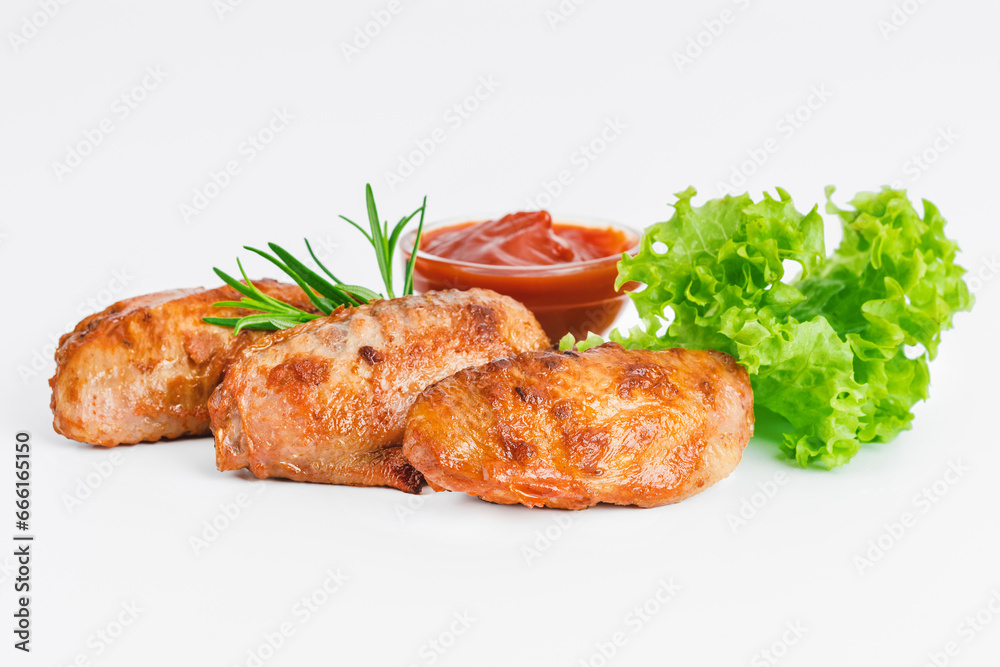 Chicken wings fried until half cooked, semi-finished product with fresh herbs on a white background. Fast food. Fast cooking.Quick cooking at home. Copy space.Fast homemade food.Raw chicken meat.
