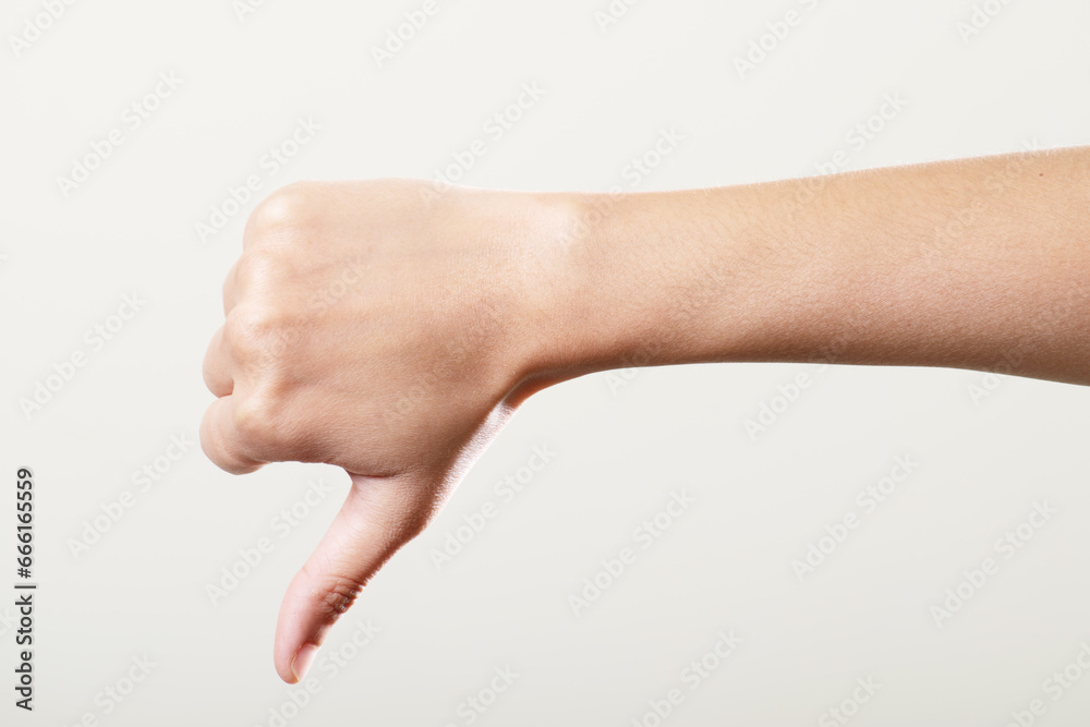 Thumbs down hand isolated on white background, disagree hand gesture - obrazy, fototapety, plakaty 