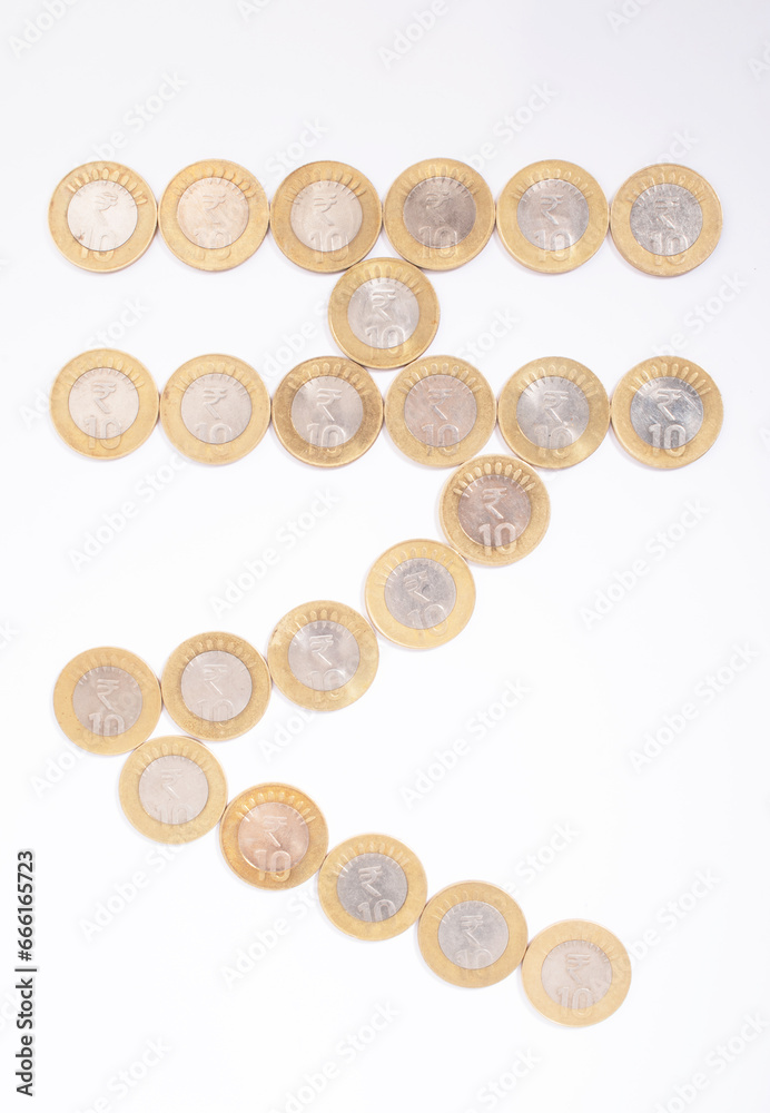 Top view of rupees symbol created by indian currency coin isolated on white background