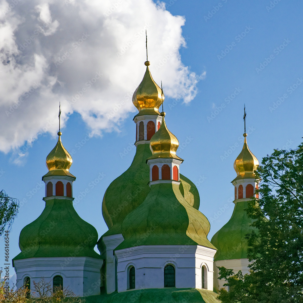 Domes of an Orthodox church against the sky. Orthodox baroque architecture. Clear sky. An old religious building.