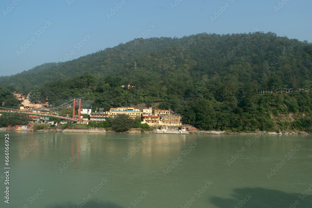 Ganga river with green mountains at rishikesh, uttarakhand