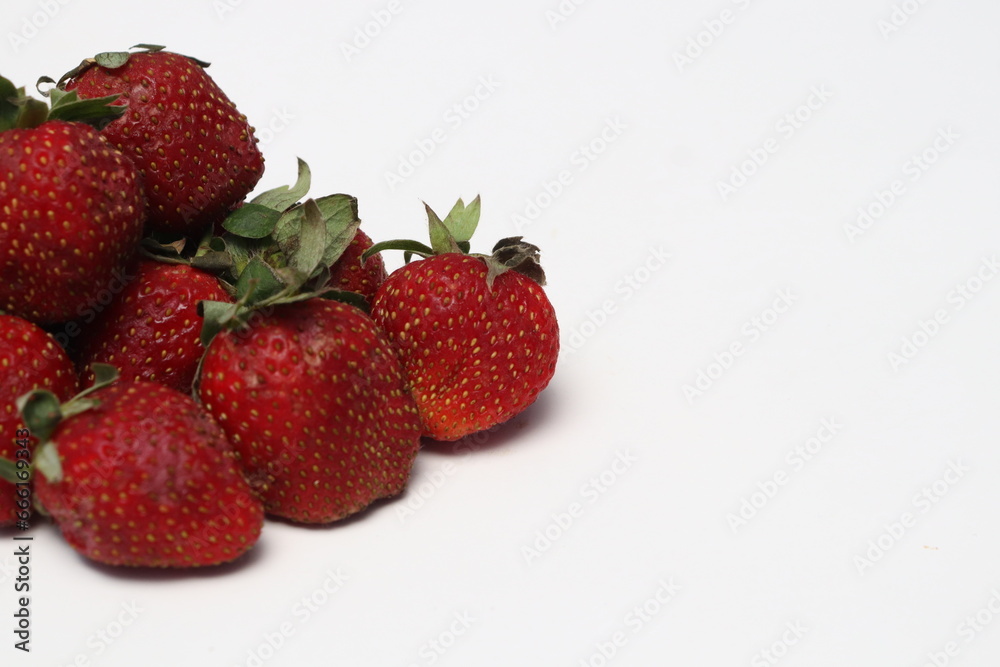 Some fresh ripe red strawberries have green leaf petals.
Some fresh ripe red strawberries have green leaf petals.