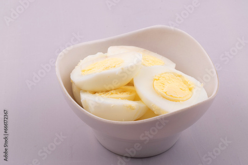 Boiled eggs in bowl on white background