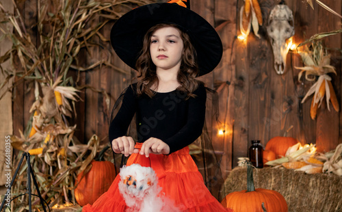 girl in a witch costume casts a spell on Halloween
