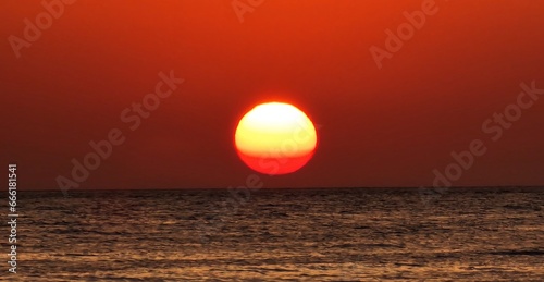 sunrise in early morning hours in egypt close to Marsa alam sun reflexion in the red sea photo