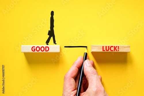 Good luck symbol. Concept words Good luck on beautiful wooden block. Beautiful yellow table yellow background. Businessman hand. Business, motivational good luck concept. Copy space.