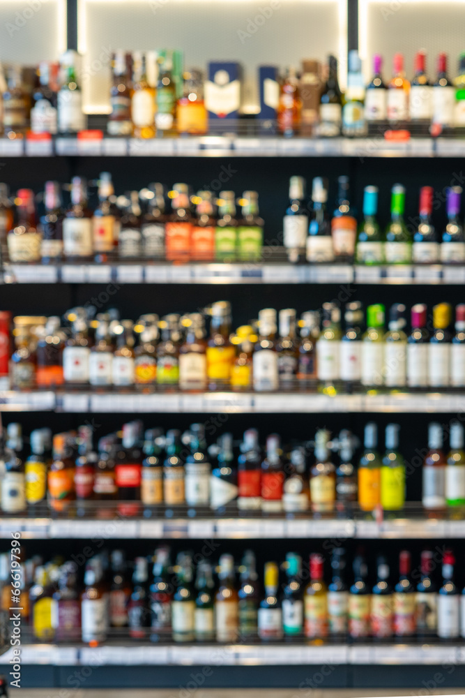 Many bottles of alcoholic beverages on a shelf in a store