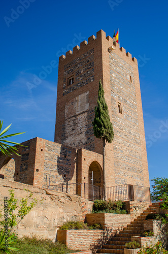 velez malaga castle over blue sky with vegetation
