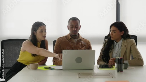 Diverse group of colleagues working together. Transgender woman discussing with colleagues at work.
 photo