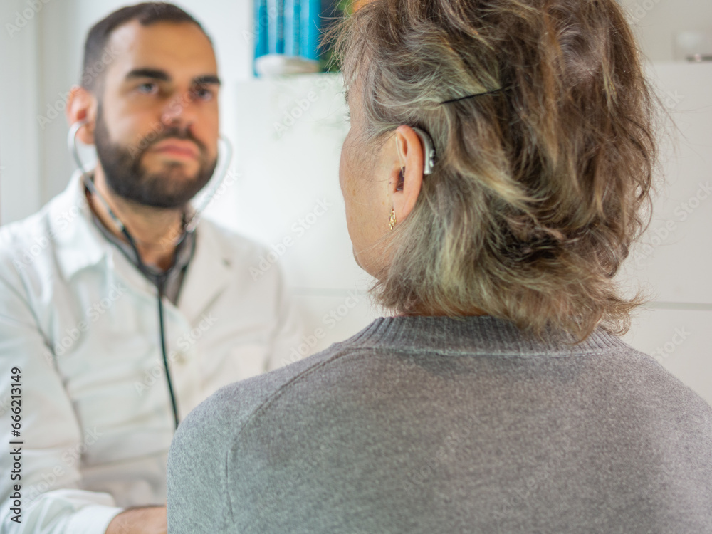 young doctor using a stethoscope with his patient