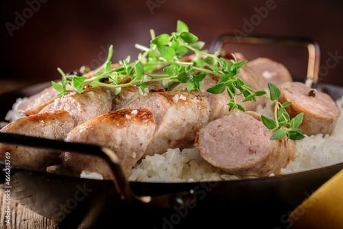 4K Image: Grilled Sausage Served Over Steaming White Rice, a Mouthwatering Dish