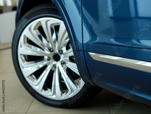 close-up of a luxury car from the side with the wheel turned out © AvokadoStudio
