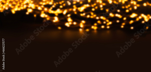Glitter vintage lights on a dark background. Gold de-focused garland lights for Christmas .