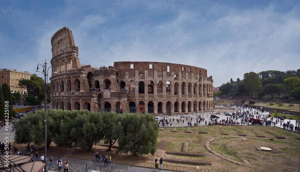 Panoramic view of the Colosseum (Colosseo, Anfiteatro Flavio)  from the Roman Forum in Rome, Italy	