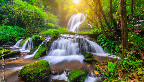 beautiful waterfall in green forest in jungle at phu tub berk mo  © Arber
