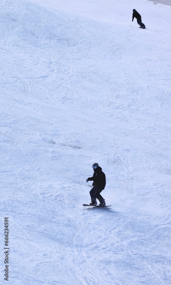 two people are out in the snow on their boards and some snow