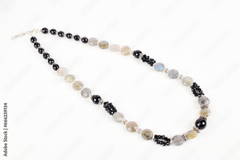Black and white bead necklace on white background Black and white bead necklace on white background