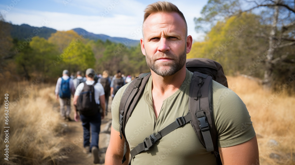 Serious Hiker with Group Explores Mountain Trail
