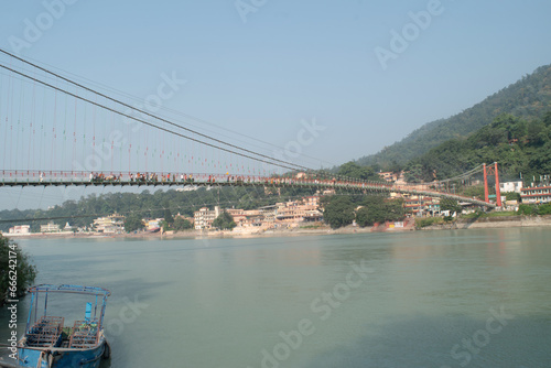 Ram jhula bridge view with holy ganga and mountain at rishikesh