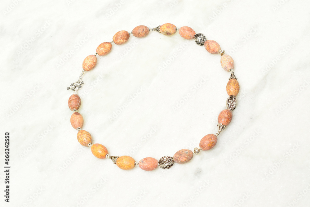 Handmade brown necklace on white background Handmade brown necklace on white background