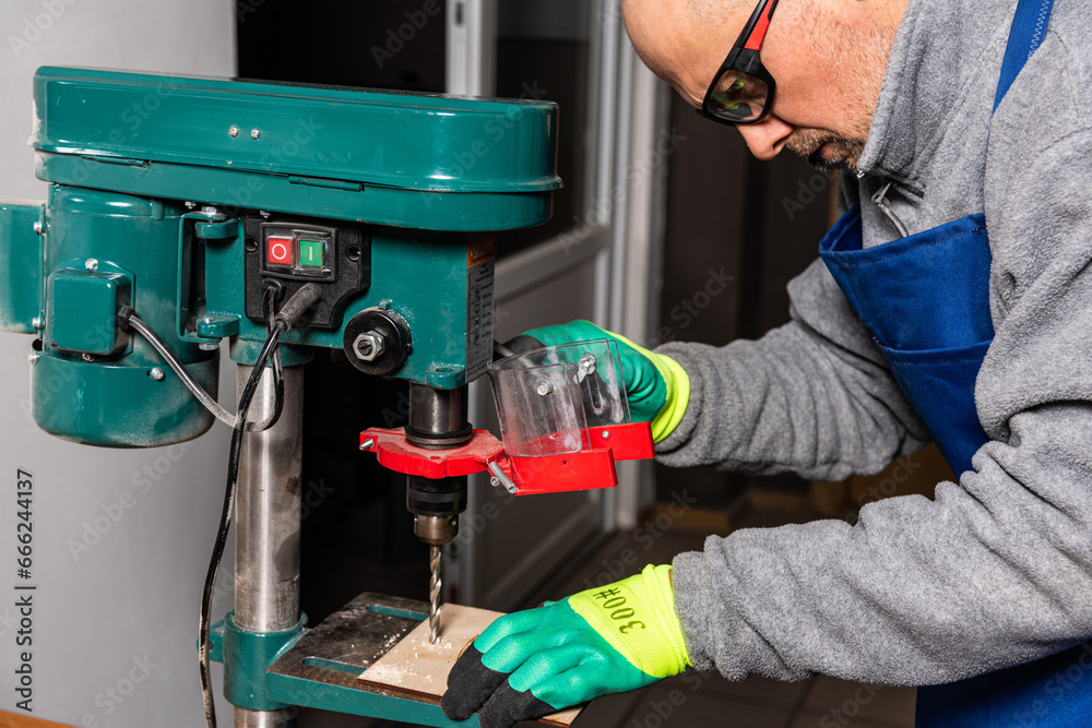 Working on vertical drilling machines in the industrial plant for producing new items Working on vertical drilling machines in the industrial plant for producing new items