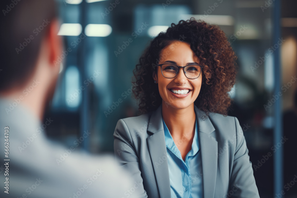 Happy middle aged woman manager shaking hands with a business partner at meeting. Happy businessman making a deal with a partner, shaking hands. Happy middle aged woman manager shaking hands with a business partner at meeting. Happy businessman making a deal with a partner, shaking hands.