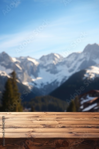 A dark wood table on a mountain cabin deck, offering breathtaking vistas of a snow-covered forest, icy lake, and snow-clad peaks. © TETIANA