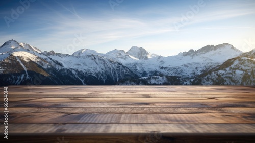 A dark wood table on the cabin deck offers perfect views of a snow-covered forest, icy lake, and snow-capped peaks. © TETIANA