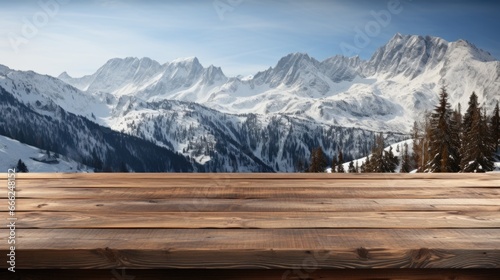 On the cabin deck, a dark wood table overlooks a snow-covered forest, icy lake, and towering, snow-draped peaks. © TETIANA