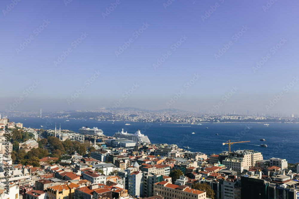 Beautiful landscape over city rooftops, bay and city in the background. View of the Bosphorus and Istanbul from the Galata Tower. Istanbul, Türkiye – October 15, 2023