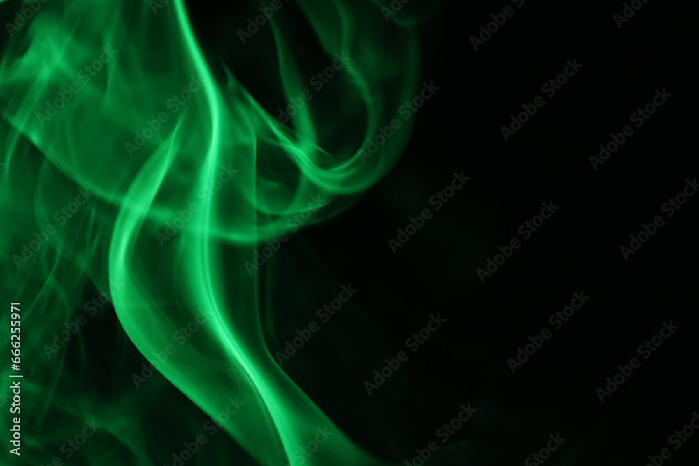Obraz premium Green lines, green smoke on a dark background, colourful abstract, green fog, minimalism, line of light 
